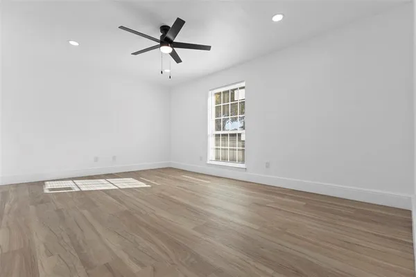 wooden floor in an empty room with a window