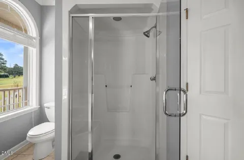 a bathroom with a shower toilet and sink