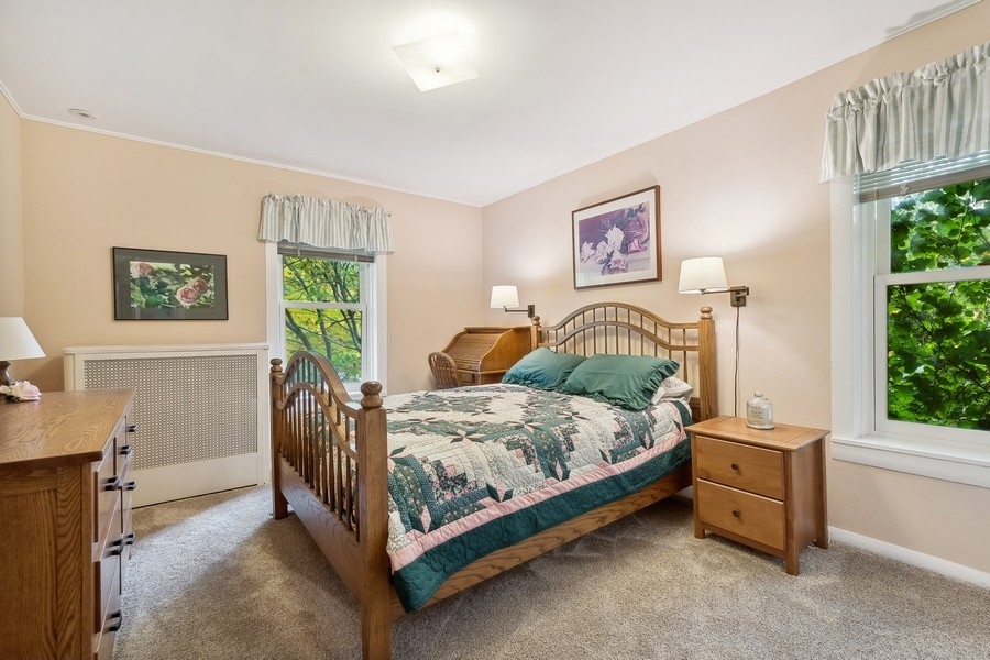 606 Barton Avenue Evanston, IL 60202 - Photo 11 of 27 a bedroom with a bed and a window
