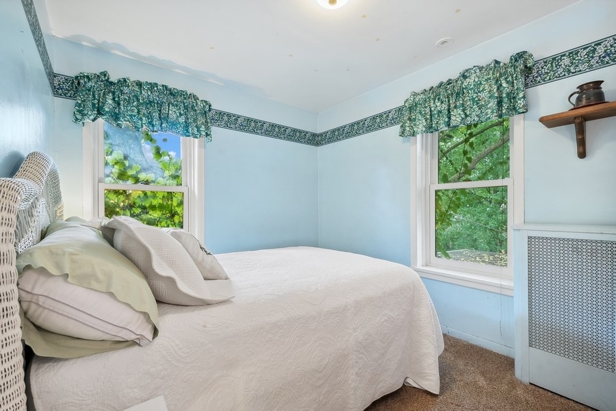 606 Barton Avenue Evanston, IL 60202 - Photo 12 of 27 a bed sitting in a bedroom next to a window