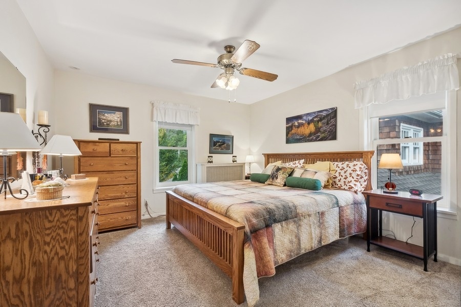 606 Barton Avenue Evanston, IL 60202 - Photo 13 of 27 a bedroom with a bed and a dresser