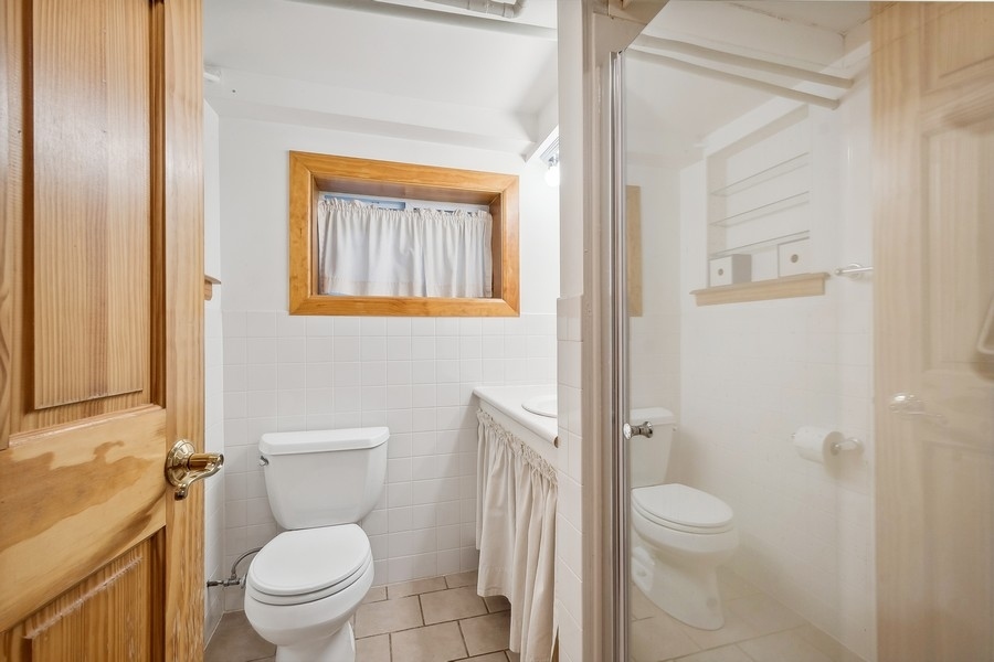 606 Barton Avenue Evanston, IL 60202 - Photo 17 of 27 a white toilet sitting next to a bathroom sink