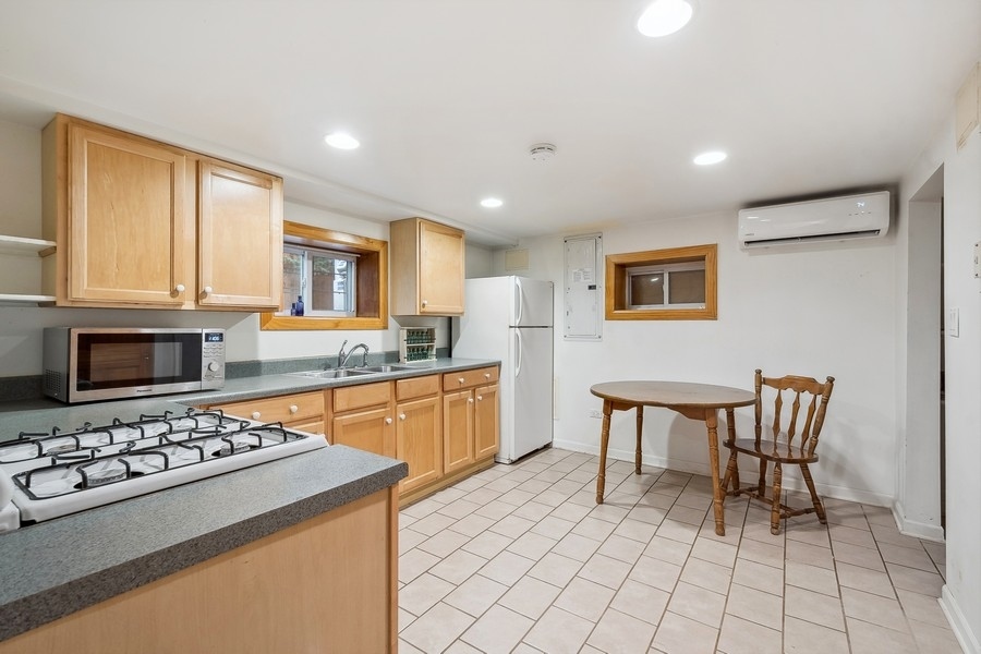 606 Barton Avenue Evanston, IL 60202 - Photo 18 of 27 a kitchen with a stove a sink and a refrigerator