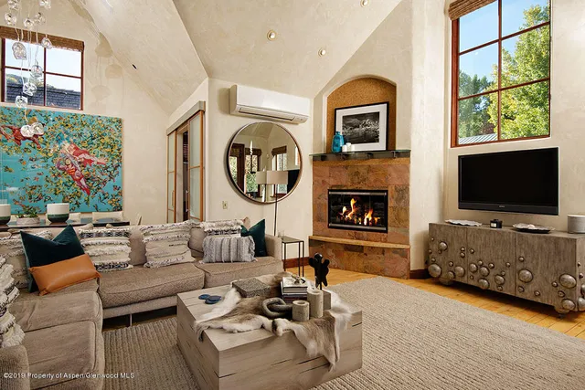 a living room with fireplace furniture and a flat screen tv