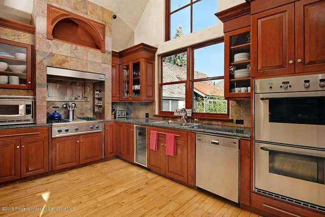 a kitchen with stainless steel appliances granite countertop a stove and cabinets