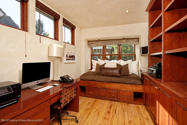 a bedroom with a workspace