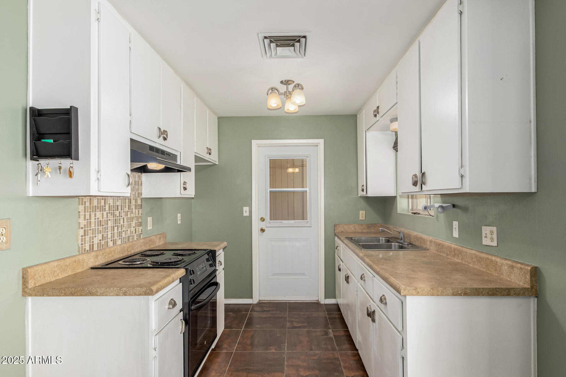 1206 South Grand Drive Apache Junction, AZ 85120 - Photo 11 of 26 a kitchen with a stove sink and cabinets