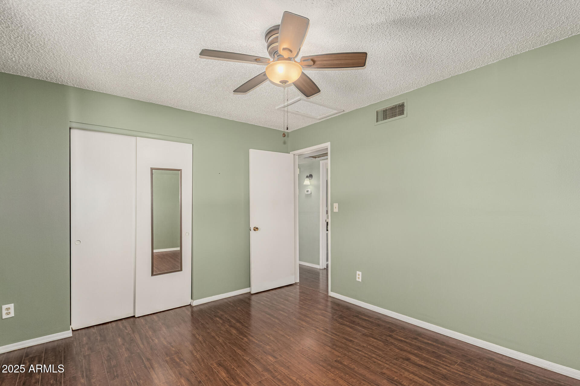 1206 South Grand Drive Apache Junction, AZ 85120 - Photo 13 of 26 a view of an empty room with wooden floor