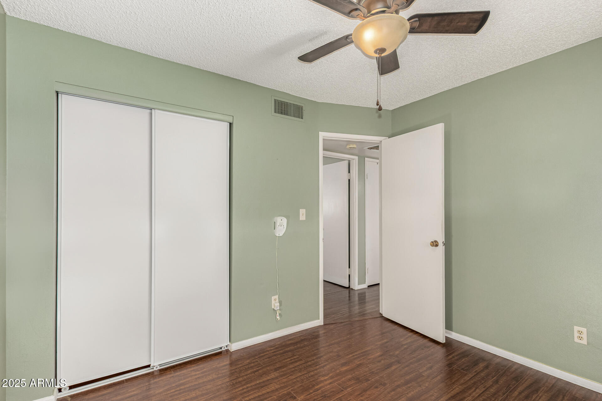 1206 South Grand Drive Apache Junction, AZ 85120 - Photo 15 of 26 a view of a room with wooden floor and chandelier fan