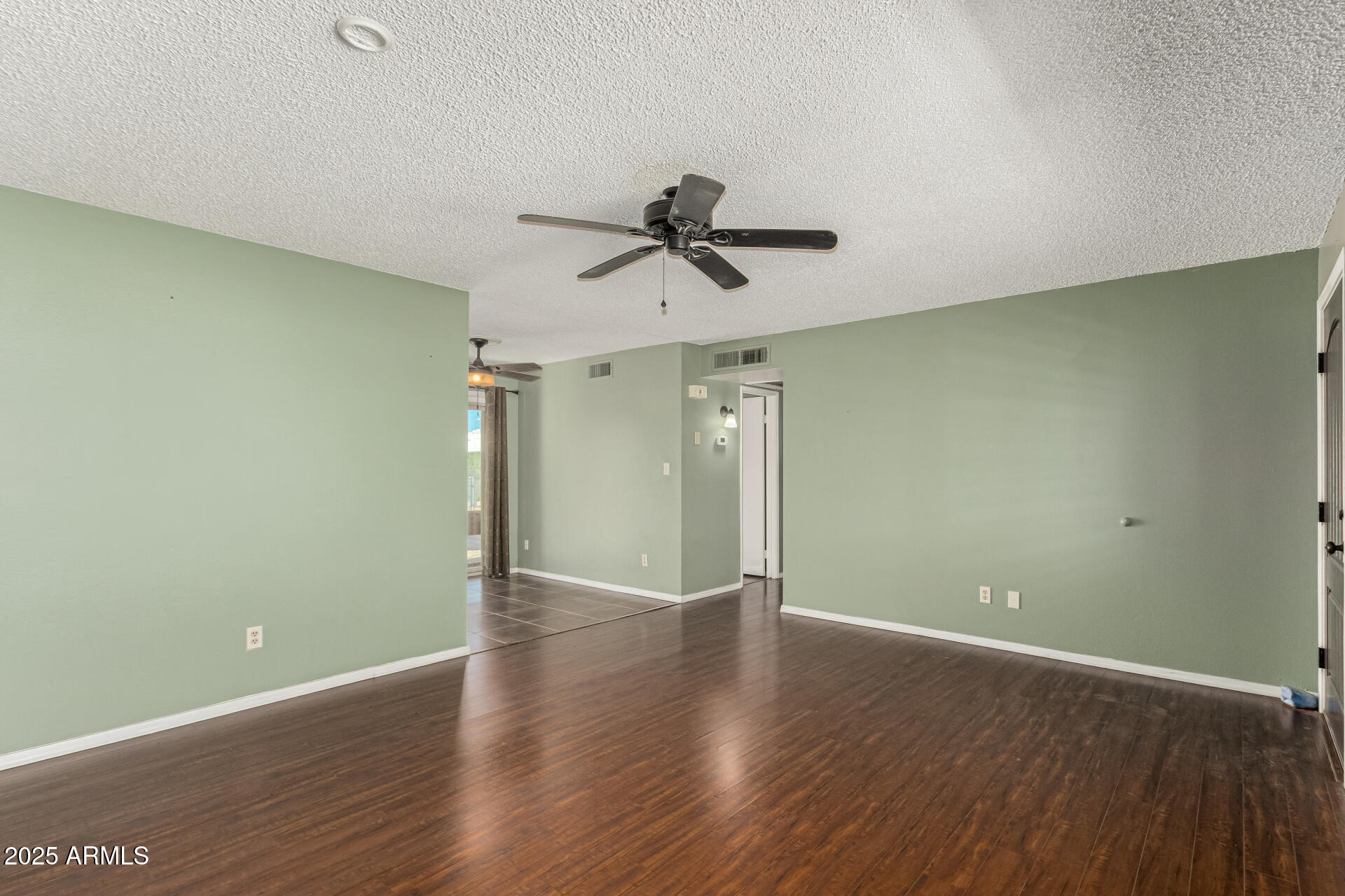 1206 South Grand Drive Apache Junction, AZ 85120 - Photo 7 of 26 wooden floor in an empty room with a window