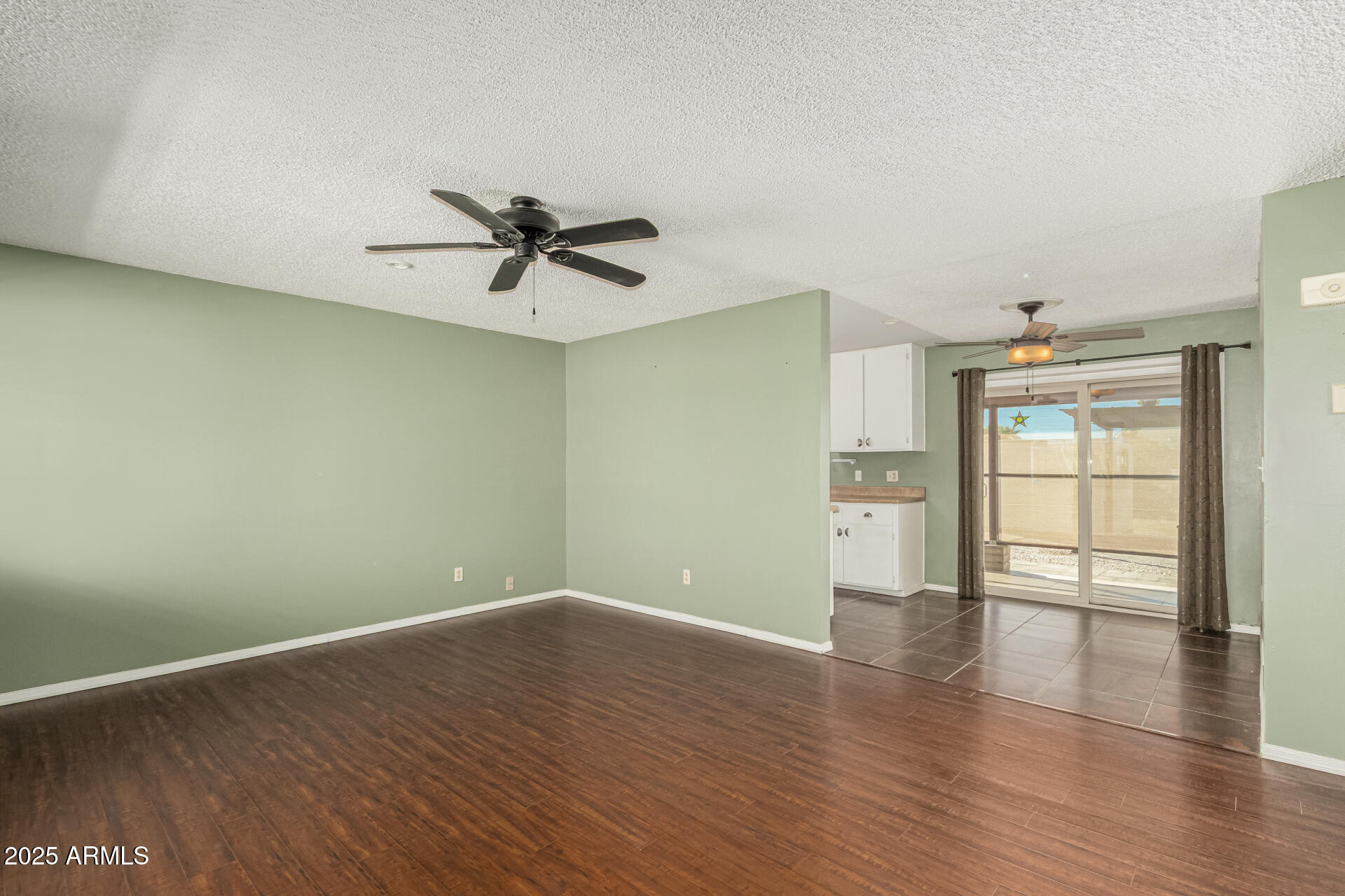 1206 South Grand Drive Apache Junction, AZ 85120 - Photo 8 of 26 wooden floor in an empty room with a window