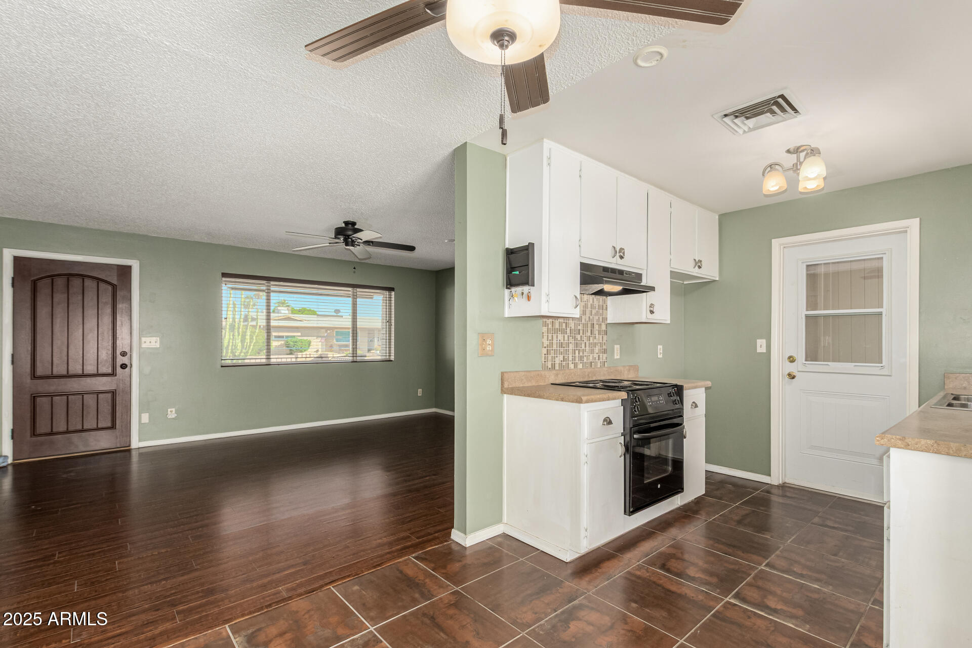 1206 South Grand Drive Apache Junction, AZ 85120 - Photo 9 of 26 a kitchen with granite countertop a stove cabinets and wooden floor
