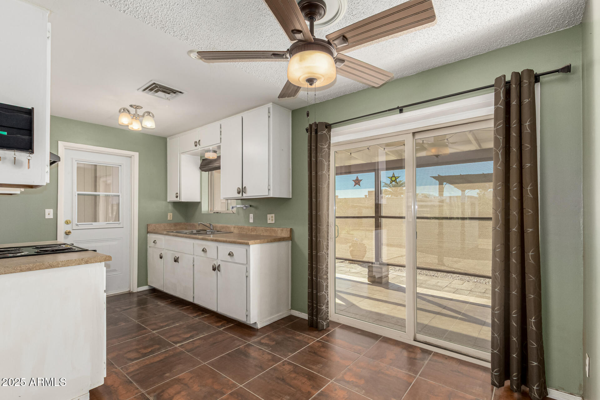 1206 South Grand Drive Apache Junction, AZ 85120 - Photo 10 of 26 a kitchen with granite countertop cabinets stainless steel appliances and a chandelier