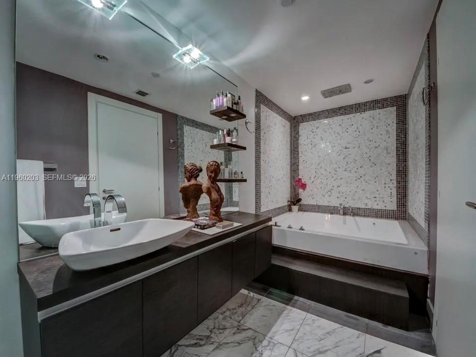 200 Biscayne Blvd Way, Unit 501 Miami, FL 33131 - Photo 11 of 15 a bathroom with a bathtub and a sink
