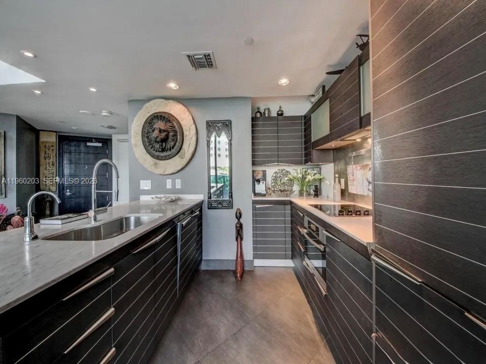 200 Biscayne Blvd Way, Unit 501 Miami, FL 33131 - Photo 5 of 15 a kitchen with a stove and a sink