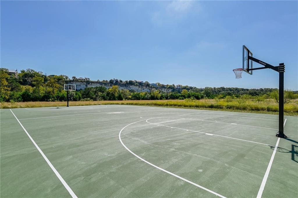 375 Housefinch Loop Leander, TX 78641 - Photo 28 of 28 An outdoor basketball court offers ample recreation space beneath clear blue skies.