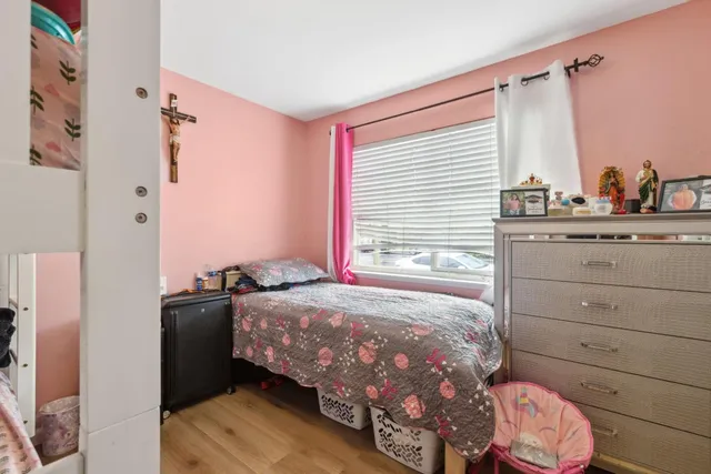 a bedroom with a bed and a dresser