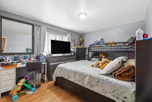 a bedroom with a bed and a flat screen tv