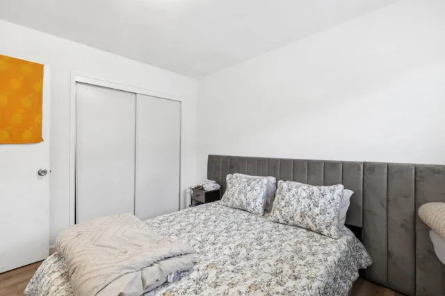 a bedroom with a bed and cabinets