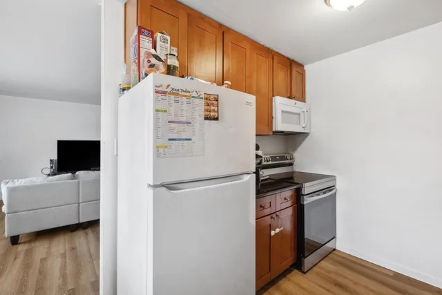 a white refrigerator freezer sitting inside of a kitchen
