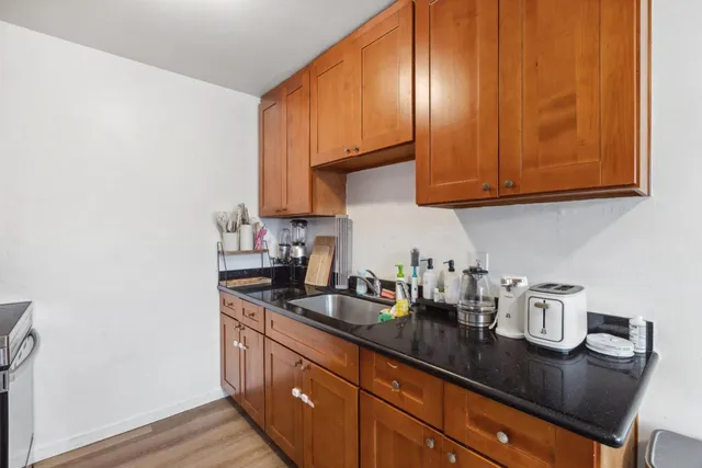 a kitchen with sink and cabinets