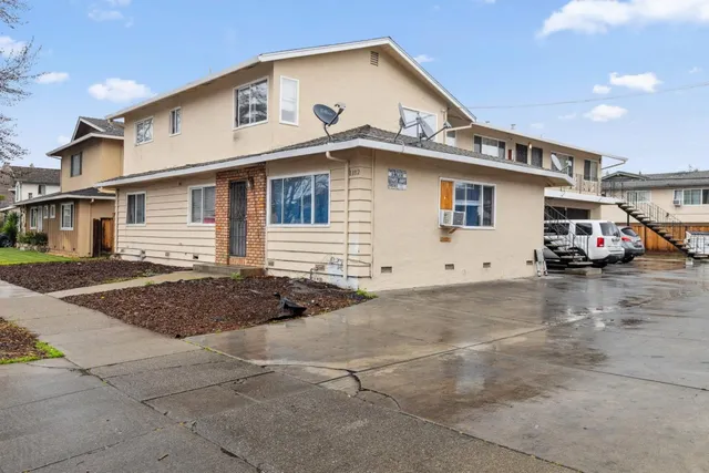 a view of a white house with a street