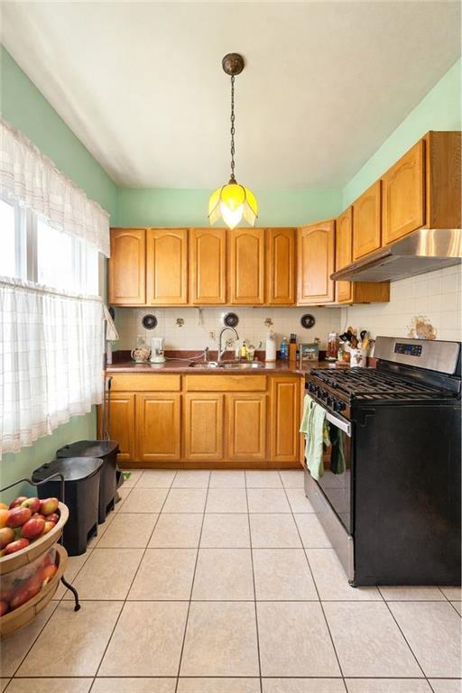 3923 Avenue R Brooklyn, NY 11234 - Photo 18 of 23 a kitchen with a cabinets appliances and a window