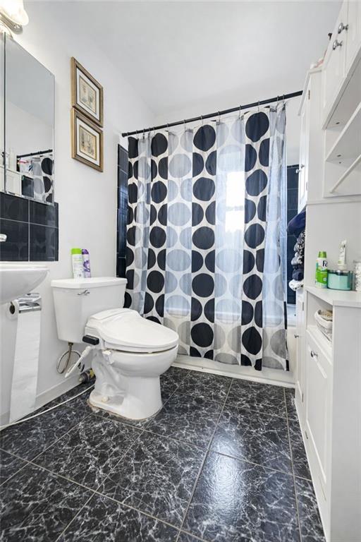 3923 Avenue R Brooklyn, NY 11234 - Photo 19 of 23 a bathroom with a toilet and a shower curtain