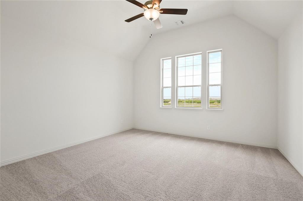 4721 Smokey Quartz Lane Arlington, TX 76005 - Photo 11 of 17 an empty room with a window and a ceiling fan