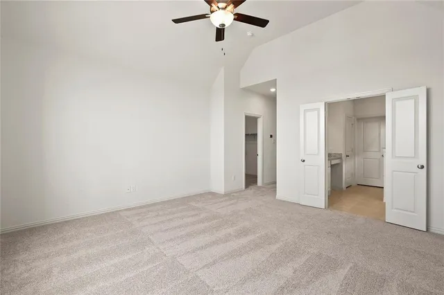 a view of an empty room with a ceiling fan