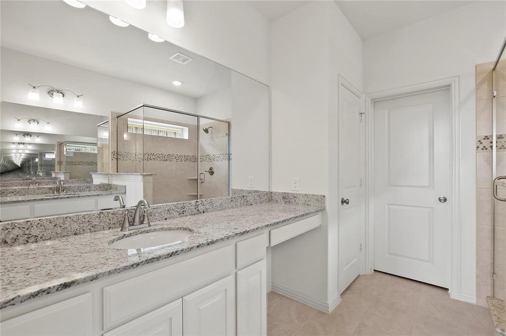 4721 Smokey Quartz Lane Arlington, TX 76005 - Photo 13 of 17 a bathroom with a granite countertop sink and a mirror