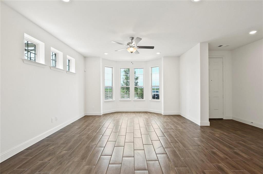 4721 Smokey Quartz Lane Arlington, TX 76005 - Photo 5 of 17 a view of an empty room with wooden floor and a window