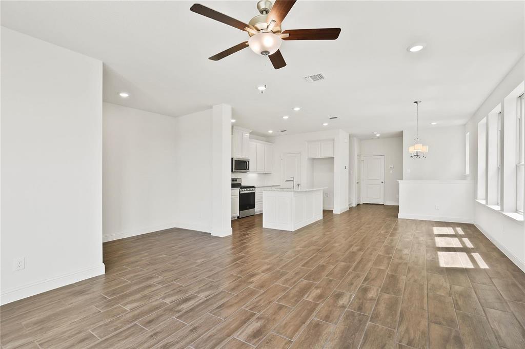 4721 Smokey Quartz Lane Arlington, TX 76005 - Photo 6 of 17 a view of a kitchen with wooden floor and a kitchen space