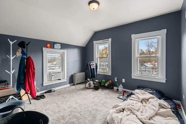 a bedroom with bed and a window