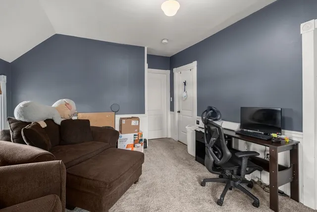 a living room with furniture and a flat screen tv with wooden floor