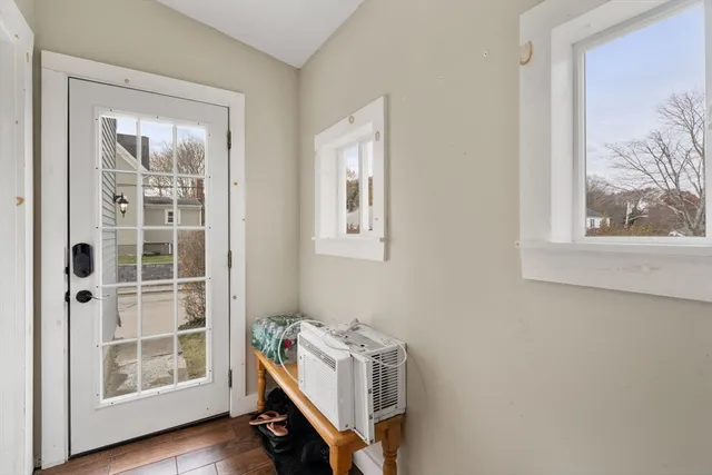 a room with gym equipment and wooden floor