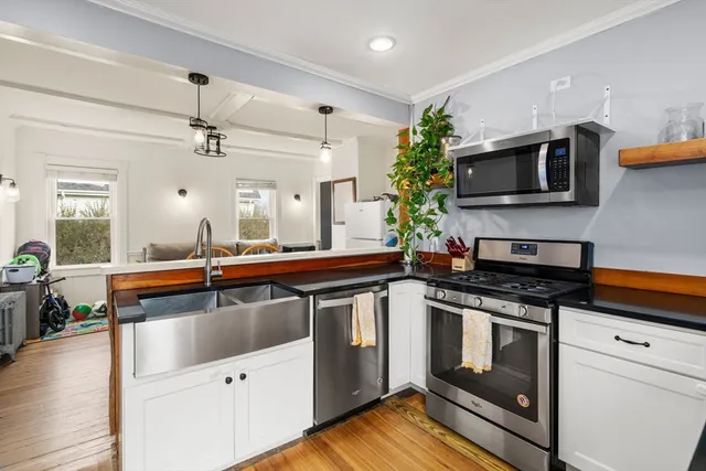 a kitchen with stainless steel appliances granite countertop a sink and stove top oven