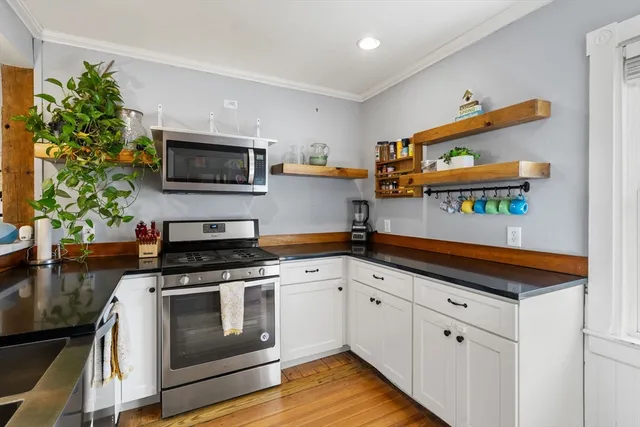 a kitchen with stainless steel appliances a stove a microwave and cabinets