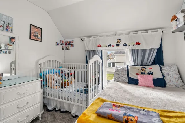 a bedroom with baby crib and hanging chair