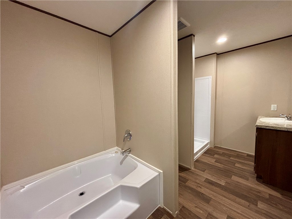 703 Double Springs Road Townville, SC 29689 - Photo 16 of 22 This functional bathroom features a tub, shower, and vanity with ample space.