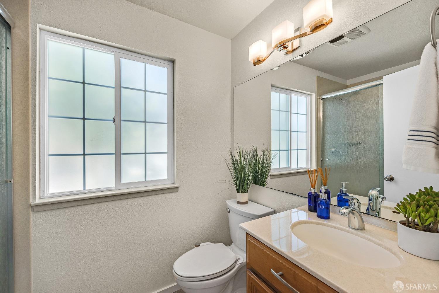 1780 Peary Way Livermore, CA 94550 - Photo 16 of 38 a bathroom with a sink a toilet a mirror and shower