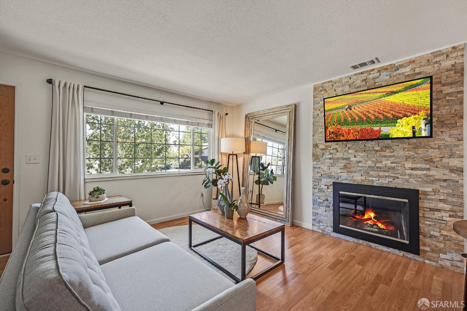 1780 Peary Way Livermore, CA 94550 - Photo 5 of 38 a living room with furniture a fireplace and a flat screen tv