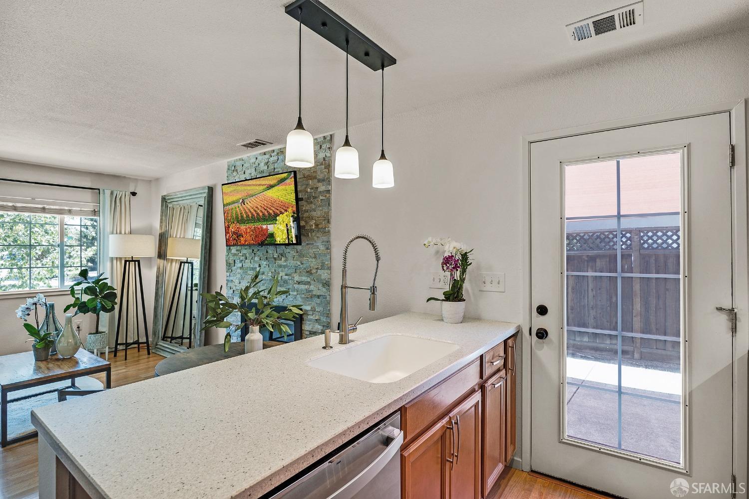 1780 Peary Way Livermore, CA 94550 - Photo 10 of 38 a room with kitchen island a large window cabinets a sink and stainless steel appliances