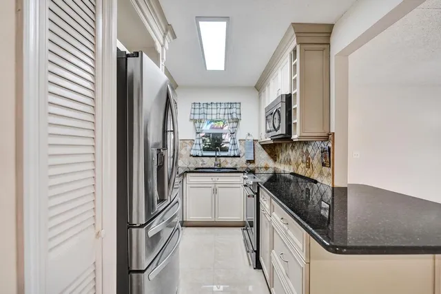 a kitchen with a refrigerator and a sink