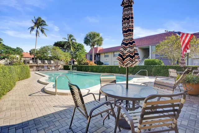 a view of a white house with a swimming pool