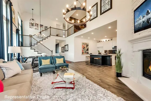 a living room with furniture and kitchen view