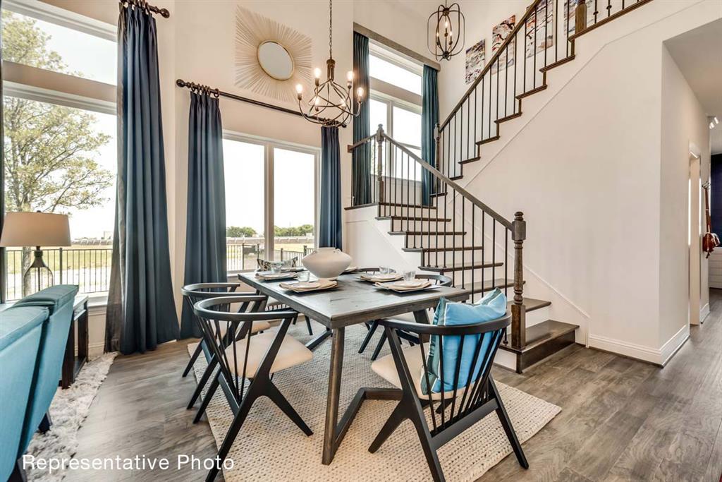 656 Blakelys Way Fate, TX 75189 - Photo 5 of 22 a view of a dining room with furniture window and wooden floor