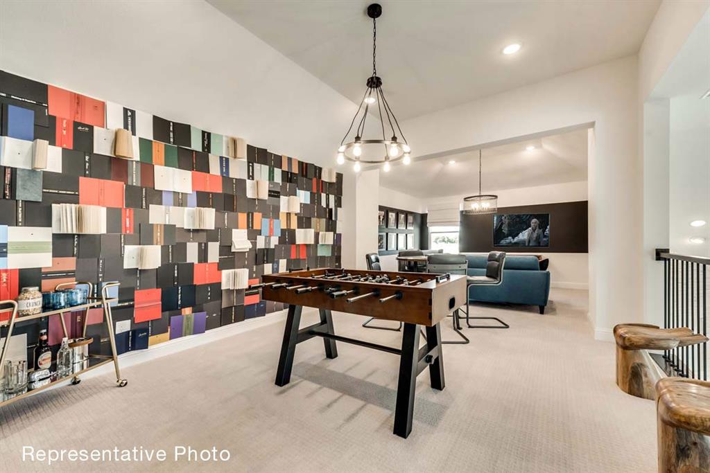656 Blakelys Way Fate, TX 75189 - Photo 8 of 22 a living room filled with furniture and a chandelier