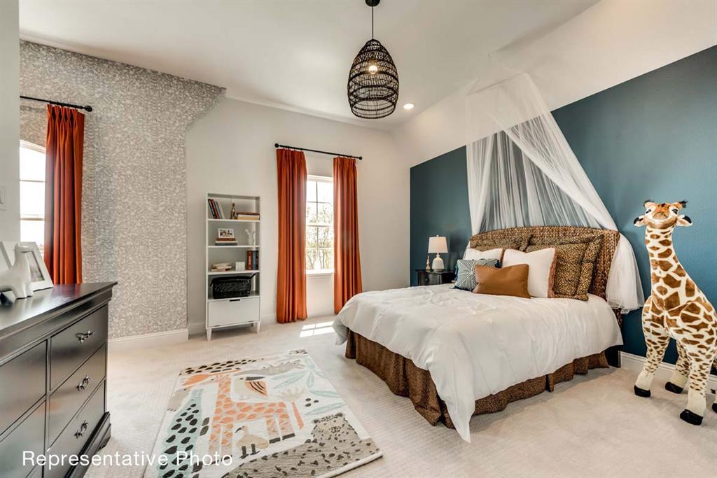 656 Blakelys Way Fate, TX 75189 - Photo 9 of 22 a bedroom with a bed a dresser and painting on the wall