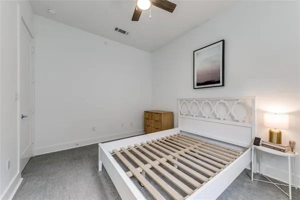 a bedroom with a bed and a ceiling fan